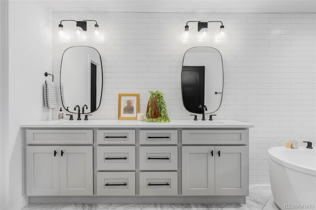 108 Arapahoe St, Golden, CO 80403 - bathroom featuring marble finish flooring, double vanity, a freestanding bath, and tile walls