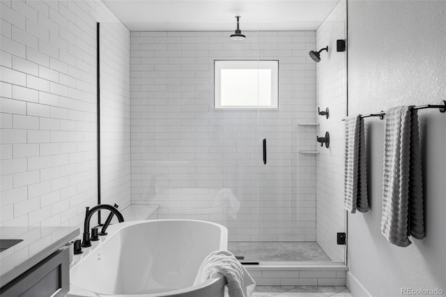 108 Arapahoe St, Golden, CO 80403 - full bath featuring a stall shower, a soaking tub, vanity, and baseboards