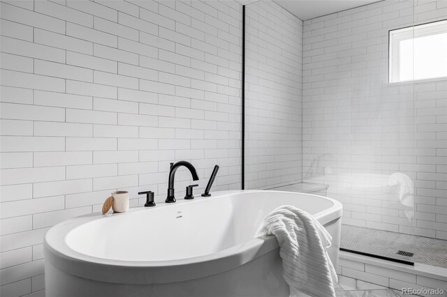 108 Arapahoe St, Golden, CO 80403 - bathroom featuring tile walls, a soaking tub, and marble finish flooring