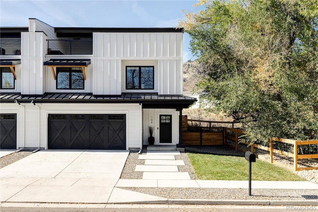 108 Arapahoe St, Golden, CO 80403 - view of front of property featuring a standing seam roof, a garage, concrete driveway, metal roof, and board and batten siding