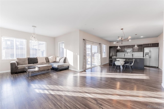 living room with dark wood finished floors and baseboards