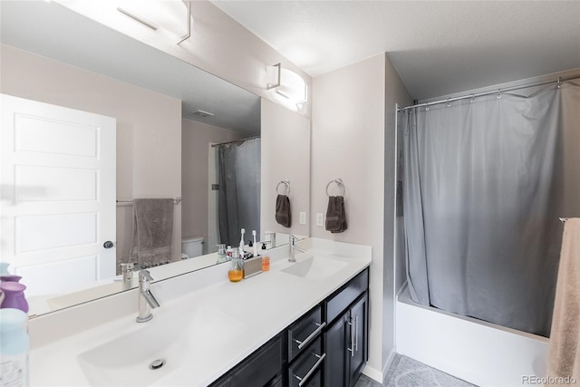 bathroom featuring toilet, shower / bathtub combination with curtain, double vanity, and a sink