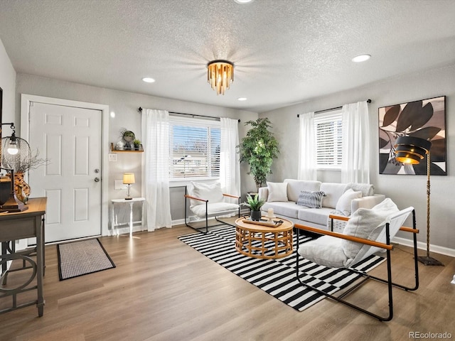 living room featuring hardwood / wood-style flooring, a wealth of natural light, and a textured ceiling