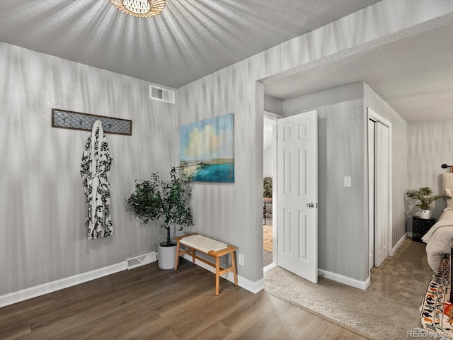 interior space with dark hardwood / wood-style floors and a textured ceiling