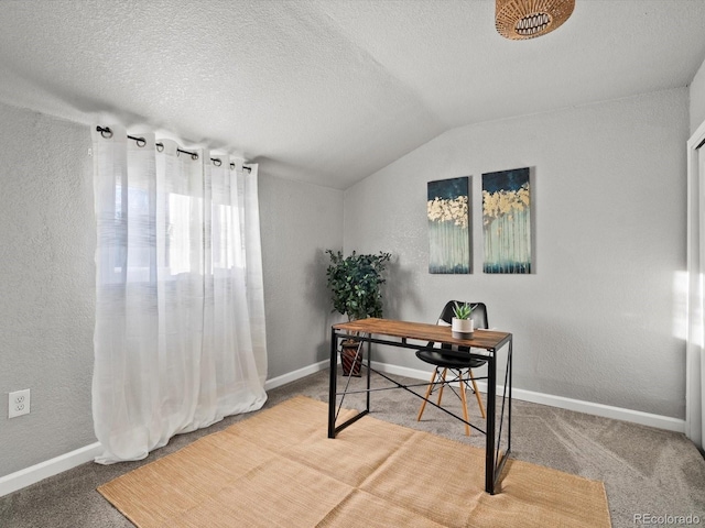 home office with vaulted ceiling, carpet floors, and a textured ceiling