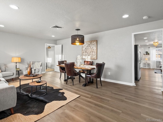 living room featuring dark hardwood / wood-style floors and a textured ceiling