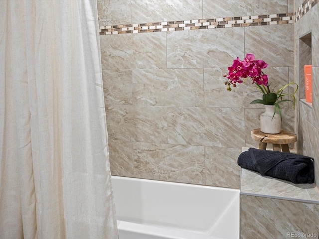 bathroom featuring shower / bathtub combination with curtain