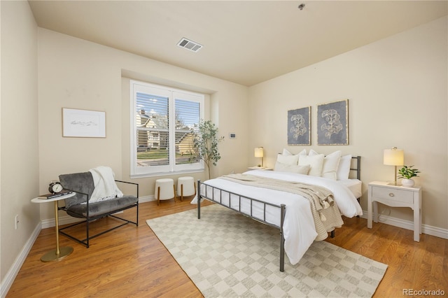 bedroom with light wood-style flooring and baseboards
