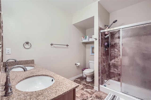 104 Noland Ct, Lyons, CO 80540 - full bath featuring a shower stall, toilet, double vanity, and tile patterned floors