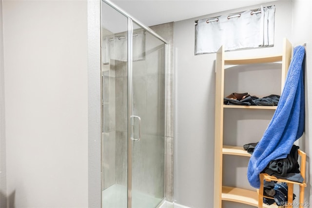 full bath featuring a spacious closet and a shower stall