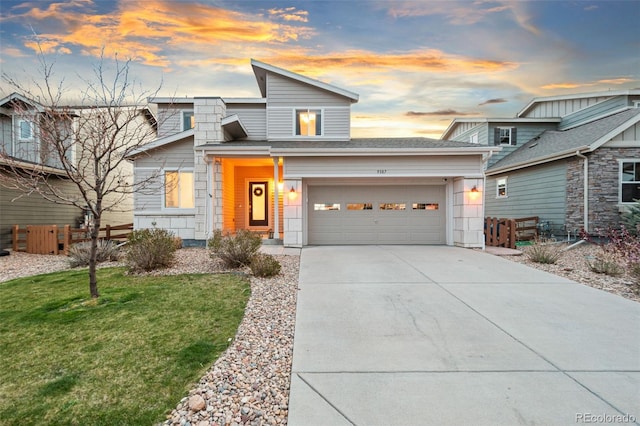 view of front facade featuring a garage, a yard, driveway, and fence