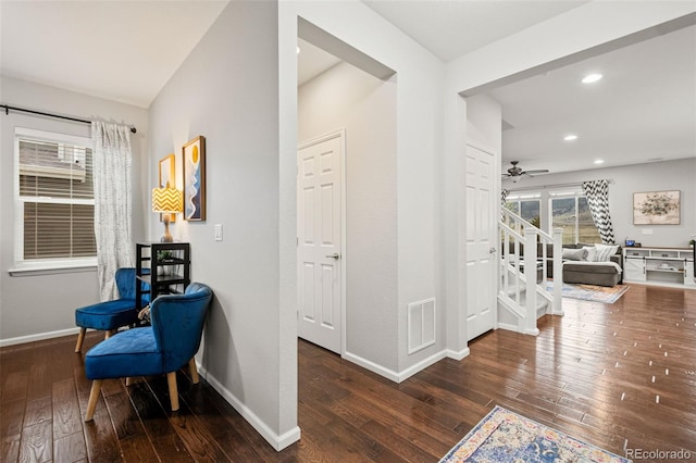 hall featuring stairs, wood-type flooring, baseboards, visible vents, and recessed lighting