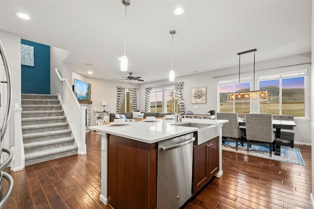 kitchen with dark wood-style floors, light countertops, dishwasher, a sink, and ceiling fan