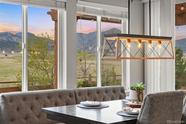 sunroom / solarium featuring a mountain view