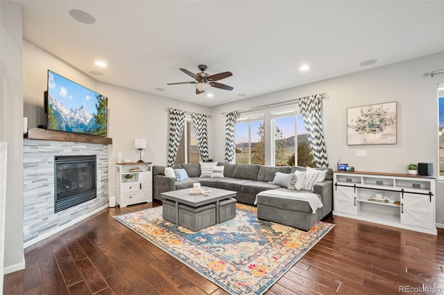 living area with dark wood finished floors, recessed lighting, ceiling fan, and a tiled fireplace