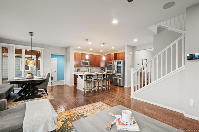 living area with baseboards, recessed lighting, stairway, and dark wood finished floors