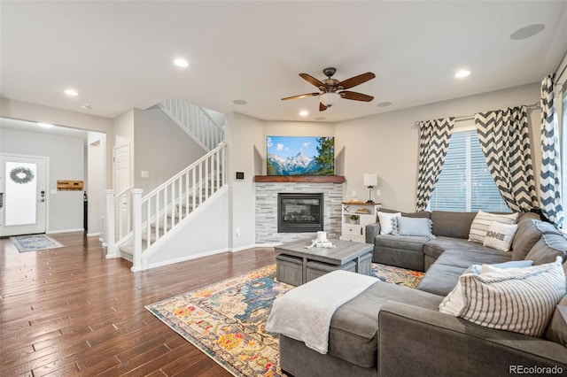 living room with dark wood-style floors, baseboards, recessed lighting, ceiling fan, and stairway
