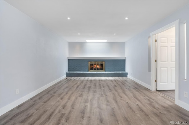 9451 W Hialeah Pl, Littleton, CO 80123 - unfurnished living room with wood finished floors, a fireplace, baseboards, and recessed lighting