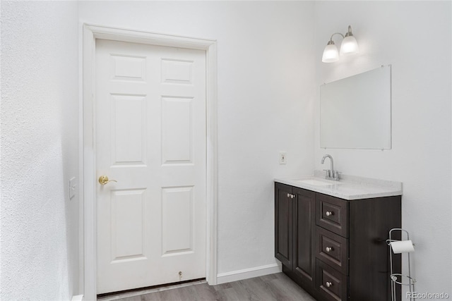 9451 W Hialeah Pl, Littleton, CO 80123 - bathroom with vanity, wood finished floors, and baseboards