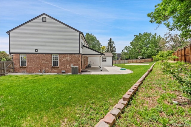 9451 W Hialeah Pl, Littleton, CO 80123 - back of property with a patio area, brick siding, and cooling unit