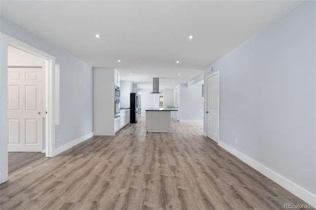 9451 W Hialeah Pl, Littleton, CO 80123 - unfurnished living room featuring light wood finished floors, recessed lighting, and baseboards