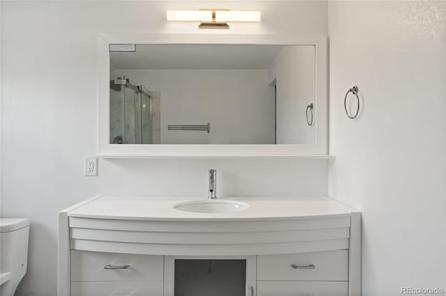 9451 W Hialeah Pl, Littleton, CO 80123 - full bath featuring toilet, vanity, and a stall shower