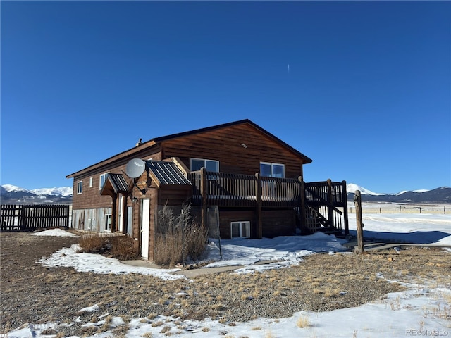 exterior space with a deck with mountain view