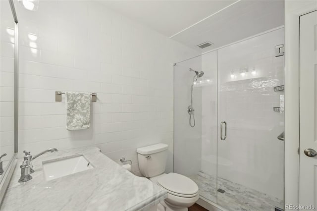 705 S Alton Way Unit 4D, Denver, CO 80247 - bathroom with a stall shower, vanity, toilet, and tile walls