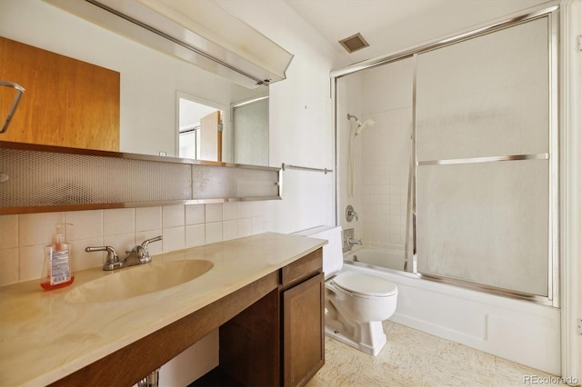 655 S Alton Way Unit 8D, Denver, CO 80247 - full bath with tasteful backsplash, bath / shower combo with glass door, toilet, and vanity