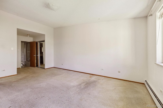 655 S Alton Way Unit 8D, Denver, CO 80247 - spare room featuring a baseboard heating unit, light carpet, and baseboards
