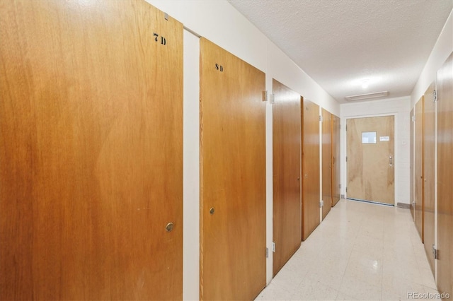 655 S Alton Way Unit 8D, Denver, CO 80247 - hall featuring a textured ceiling