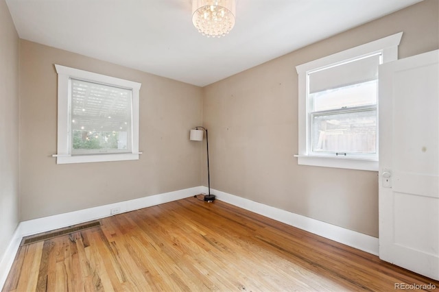 3044 W 40th Ave, Denver, CO 80211 - empty room with a chandelier and wood finished floors
