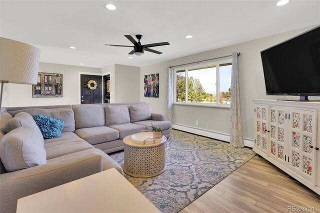 living room featuring ceiling fan, recessed lighting, wood finished floors, a baseboard heating unit, and baseboards
