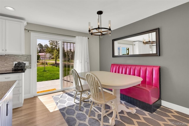dining room with a chandelier, light wood-style floors, recessed lighting, and baseboards