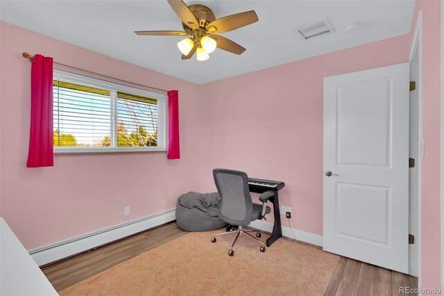 office featuring a baseboard heating unit, wood finished floors, ceiling fan, and baseboards
