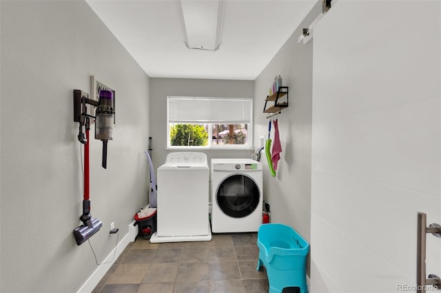 laundry area with washer and dryer and baseboards