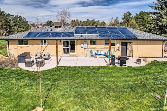 back of house with brick siding and a patio area