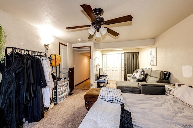 bedroom with carpet flooring, ceiling fan, and a textured ceiling