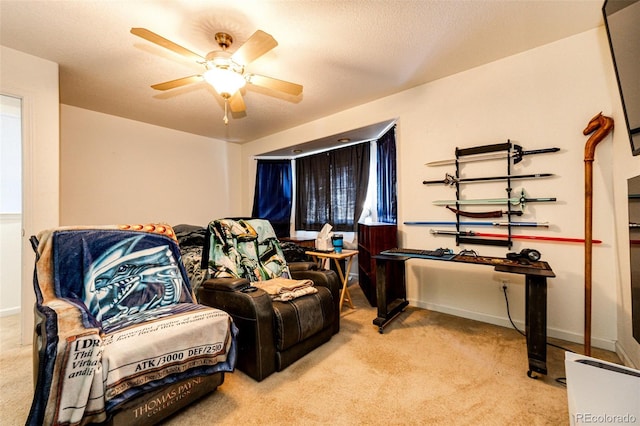 living area featuring light carpet and ceiling fan