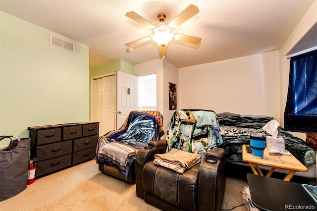 bedroom featuring ceiling fan, light colored carpet, and a closet