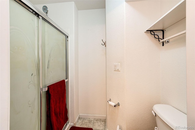 bathroom featuring toilet and walk in shower