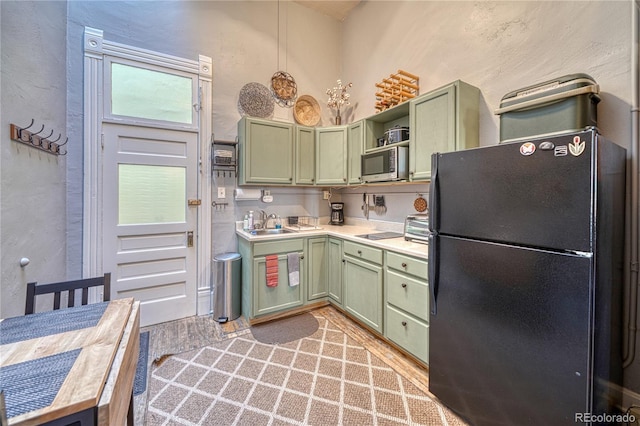 kitchen with green cabinets, light countertops, open shelves, and black appliances