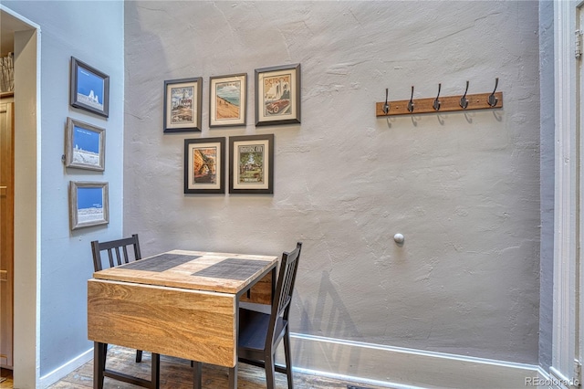 dining space featuring baseboards