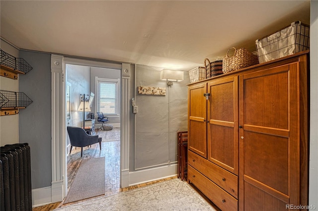 interior space featuring baseboards and radiator