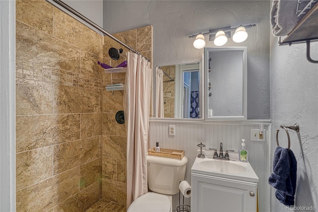 bathroom featuring curtained shower, vanity, and toilet