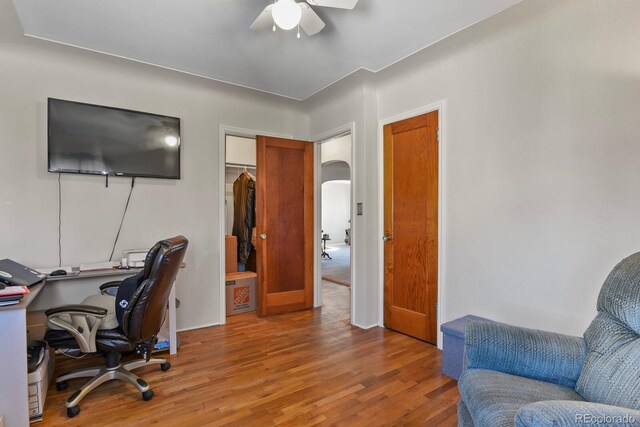 4546 S Logan St, Englewood, CO 80113 - office area featuring ceiling fan, wood finished floors, and arched walkways