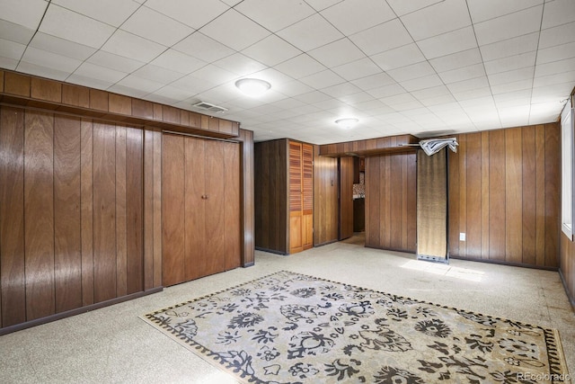 4546 S Logan St, Englewood, CO 80113 - unfurnished bedroom with wood walls, a closet, and baseboards