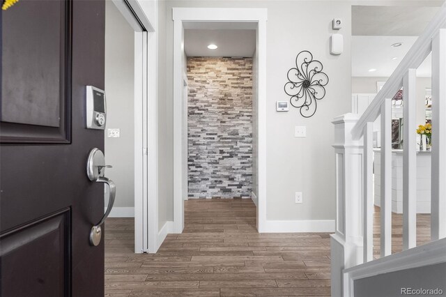 hallway with hardwood / wood-style flooring