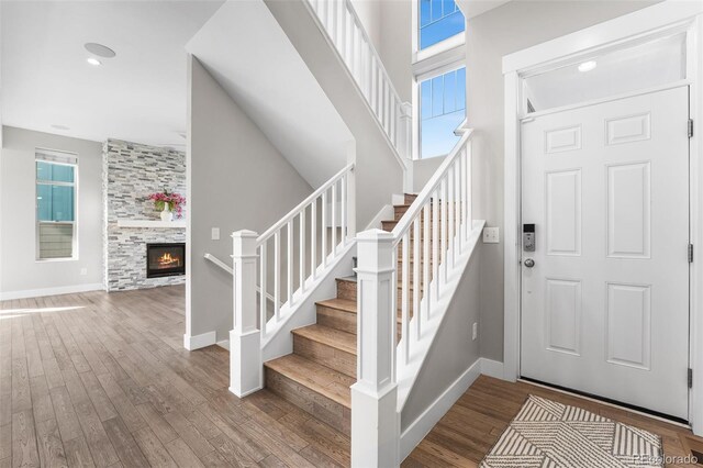 entryway featuring hardwood / wood-style floors, a fireplace, and a wealth of natural light