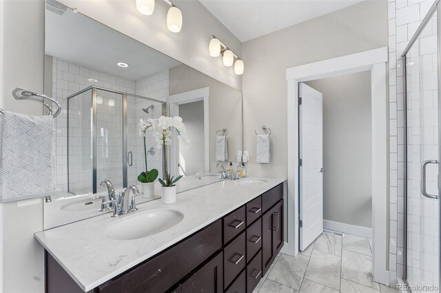 bathroom featuring vanity and a shower with shower door